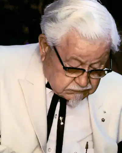 Colonel Harland Sanders in his white suit and black string tie